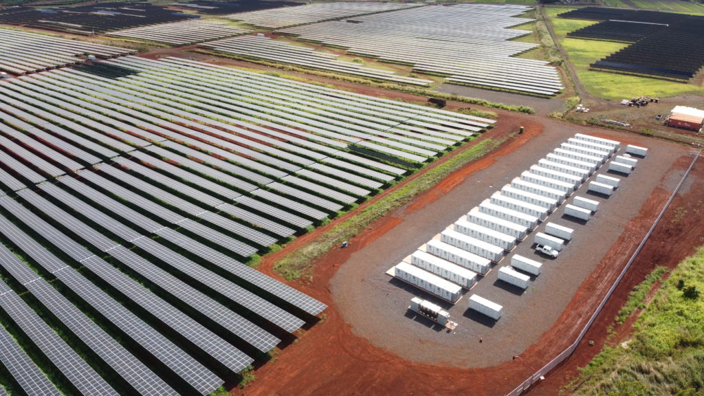 Rows or solar panels and battery storage from an aerial view